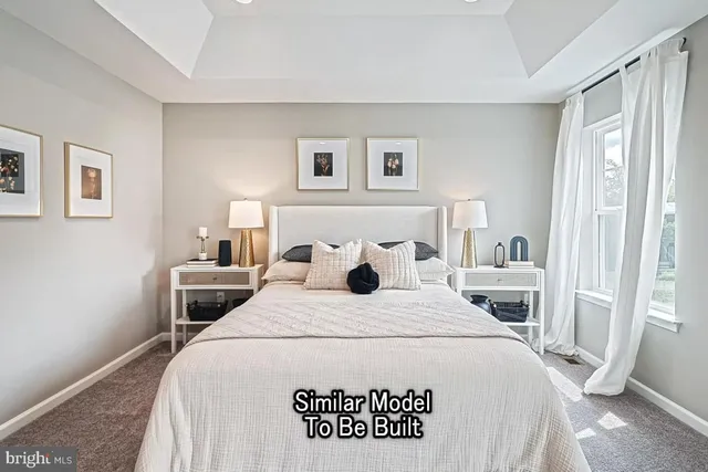 a bedroom with a bed and a view of kitchen