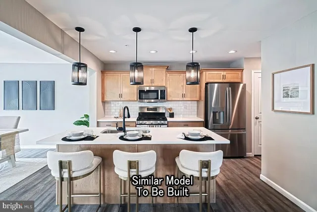 a kitchen with stainless steel appliances kitchen island granite countertop a refrigerator a stove a kitchen island a dining table and chairs