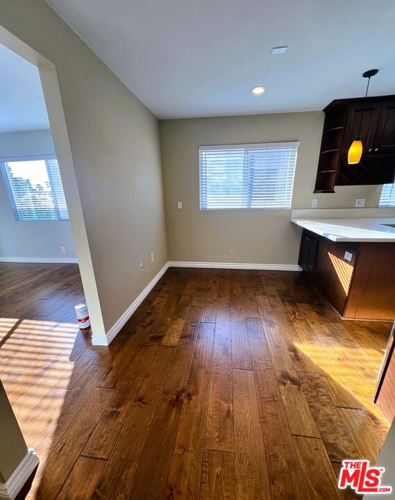 1122 10th Street, Unit 4 Santa Monica, CA 90403 - Photo 4 of 18 wooden floor in an empty room with a window and wooden floor