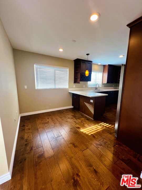 1122 10th Street, Unit 4 Santa Monica, CA 90403 - Photo 5 of 18 a view of kitchen and living room with wooden floor