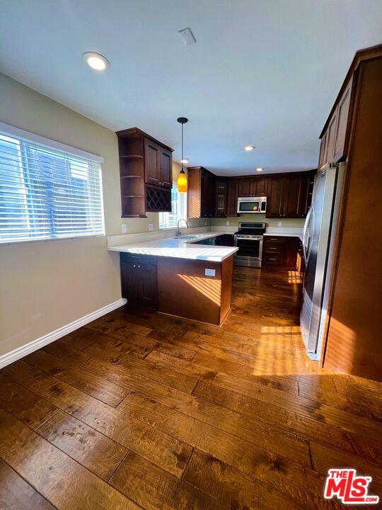 1122 10th Street, Unit 4 Santa Monica, CA 90403 - Photo 6 of 18 a living room with stainless steel appliances kitchen island granite countertop furniture a rug and a window