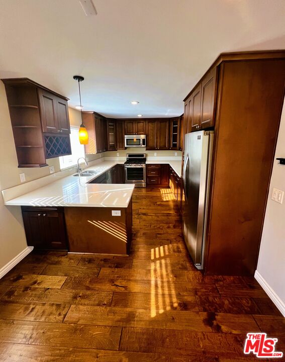 1122 10th Street, Unit 4 Santa Monica, CA 90403 - Photo 7 of 18 a kitchen with stainless steel appliances granite countertop a refrigerator a stove and a sink