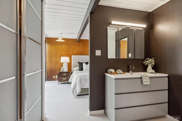 a bathroom with a sink vanity and a mirror