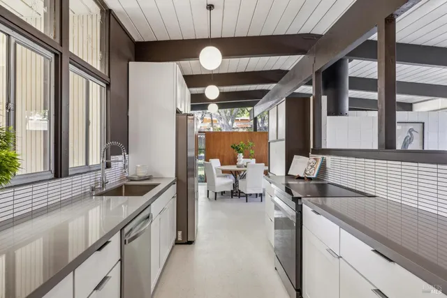 a kitchen with stainless steel appliances granite countertop sink stove and cabinets