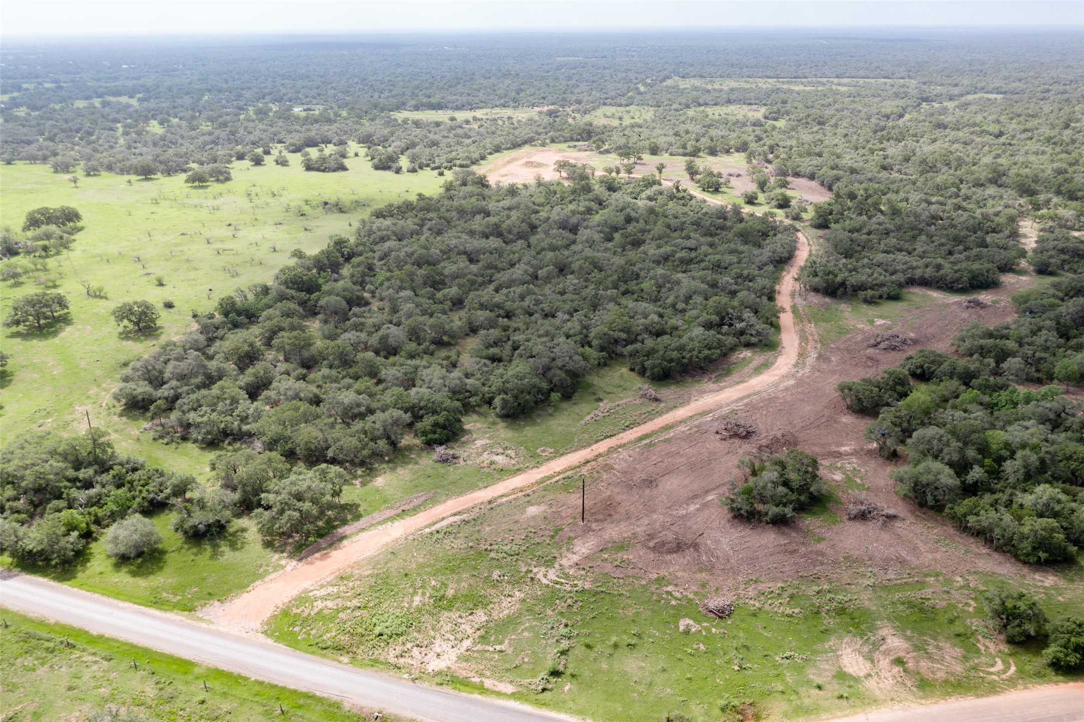 54.68-acres Cattle Guard Road Cuero, TX 77954 - Photo 12 of 50 an aerial view of residential houses with outdoor space and trees