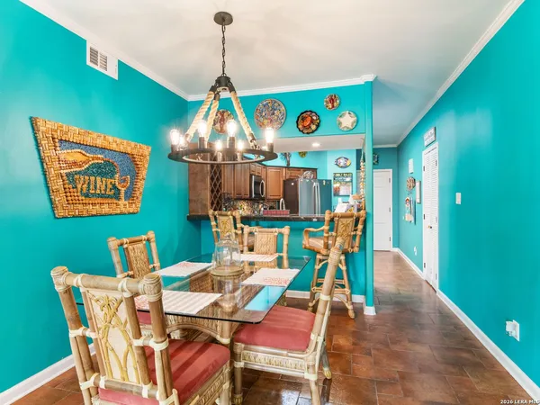 a dining room filled with furniture and a chandelier