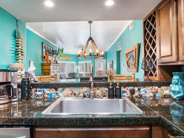 a kitchen with stainless steel appliances wooden cabinets and a sink