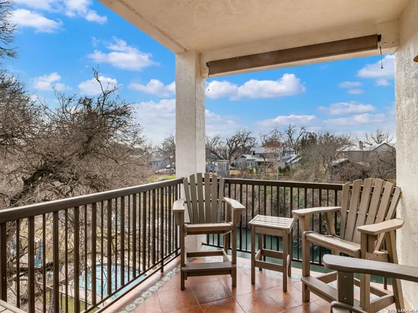 a view of a chair and table on the roof deck