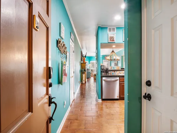 a hallway with a dining table and chairs