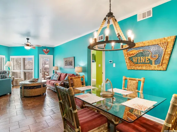 a living room with furniture a window and kitchen view