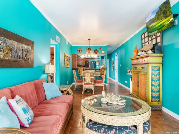 a living room with furniture and a dining table