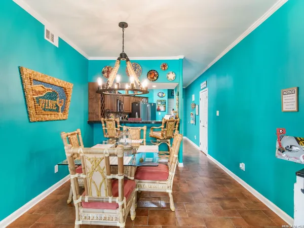 a dining room with furniture and a wooden floor
