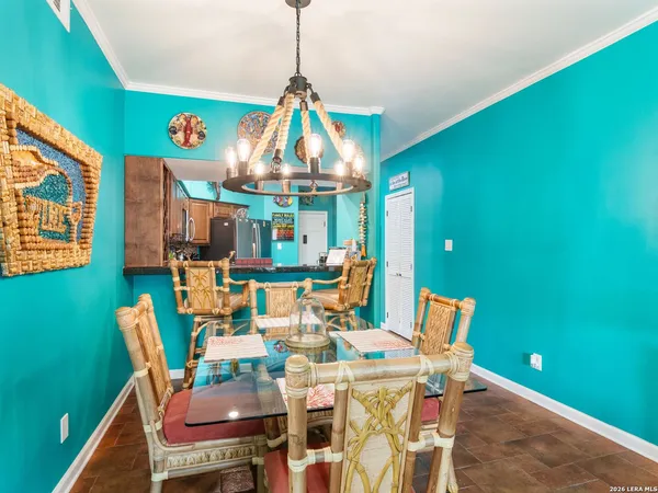 a dining room with furniture and a chandelier