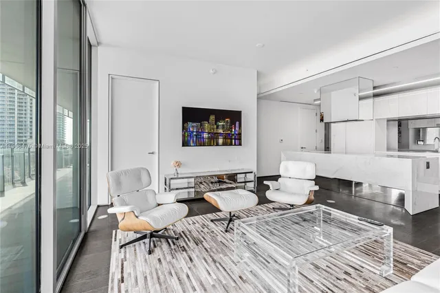 a living room with lots of furniture and wooden floor