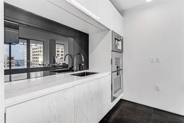 a view of a kitchen with a sink and cabinets