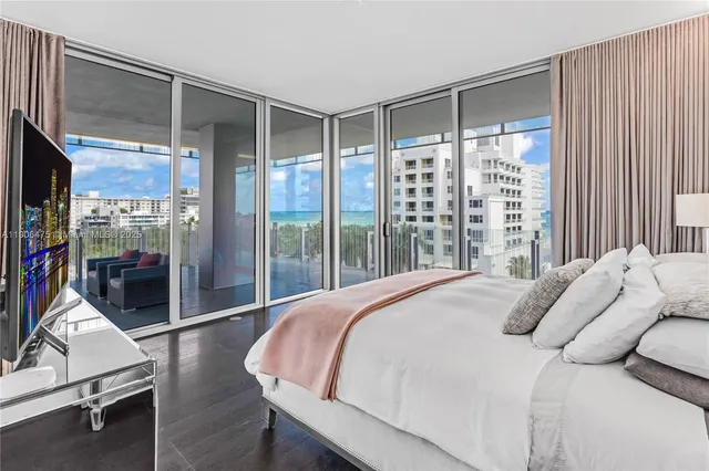 a bedroom with a bed and glass door