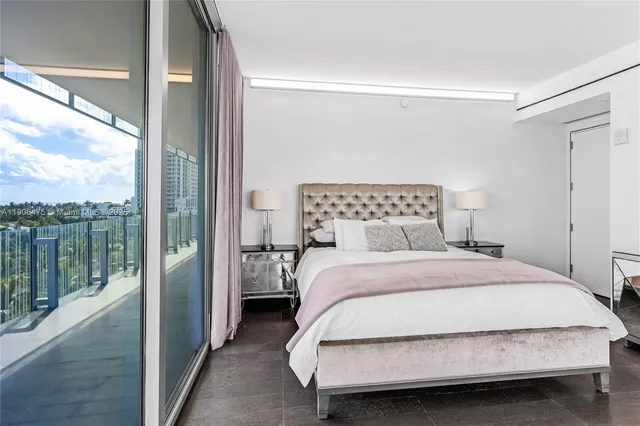 a bedroom with a bed and glass door