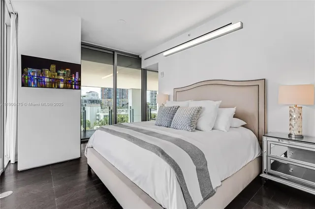 a bedroom with a large bed and a window