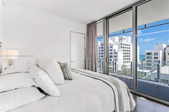 a bedroom with a large bed and a large window