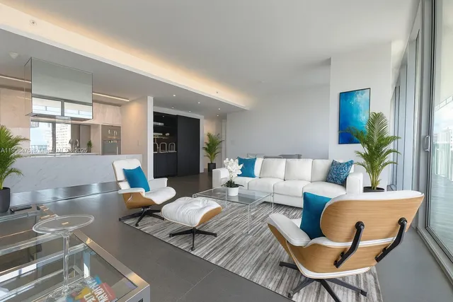 a living room with furniture and a potted plant