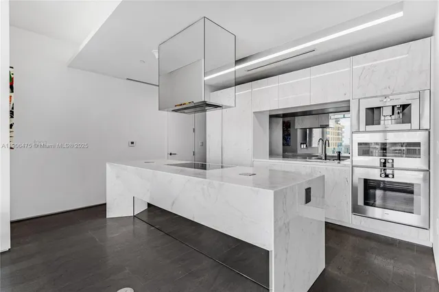 a view of kitchen with stainless steel appliances granite countertop white cabinets and refrigerator