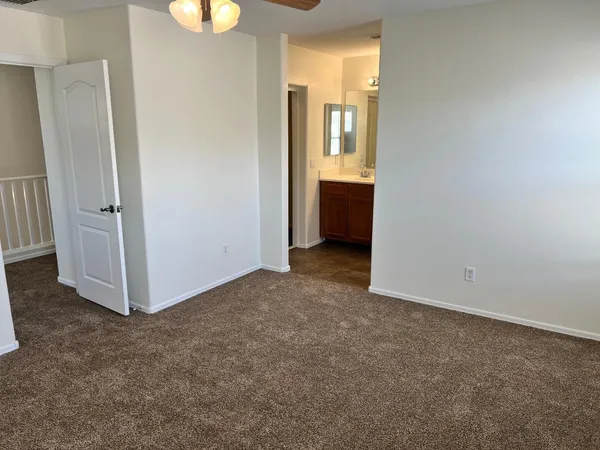 an empty room with windows and closet