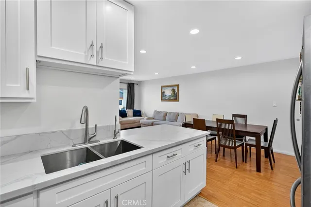 a kitchen with granite countertop a sink and cabinets
