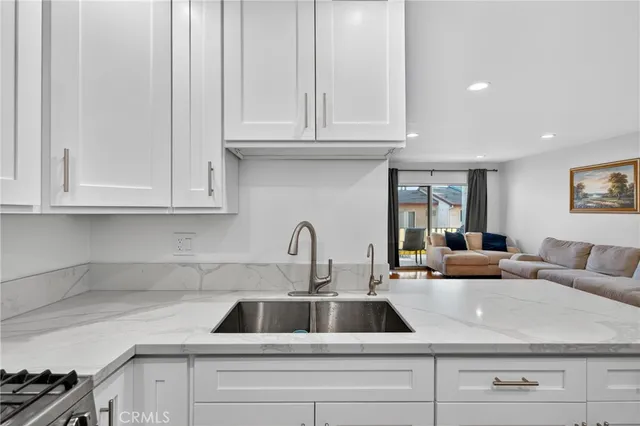 a kitchen with appliances a sink and cabinets