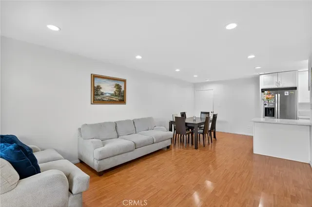 a living room with furniture and kitchen view
