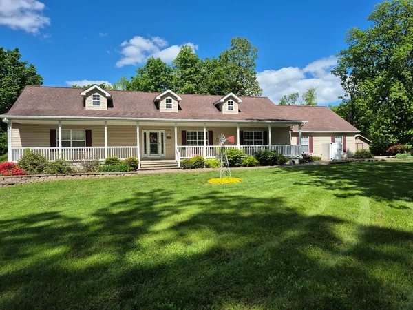 a front view of a house with a garden