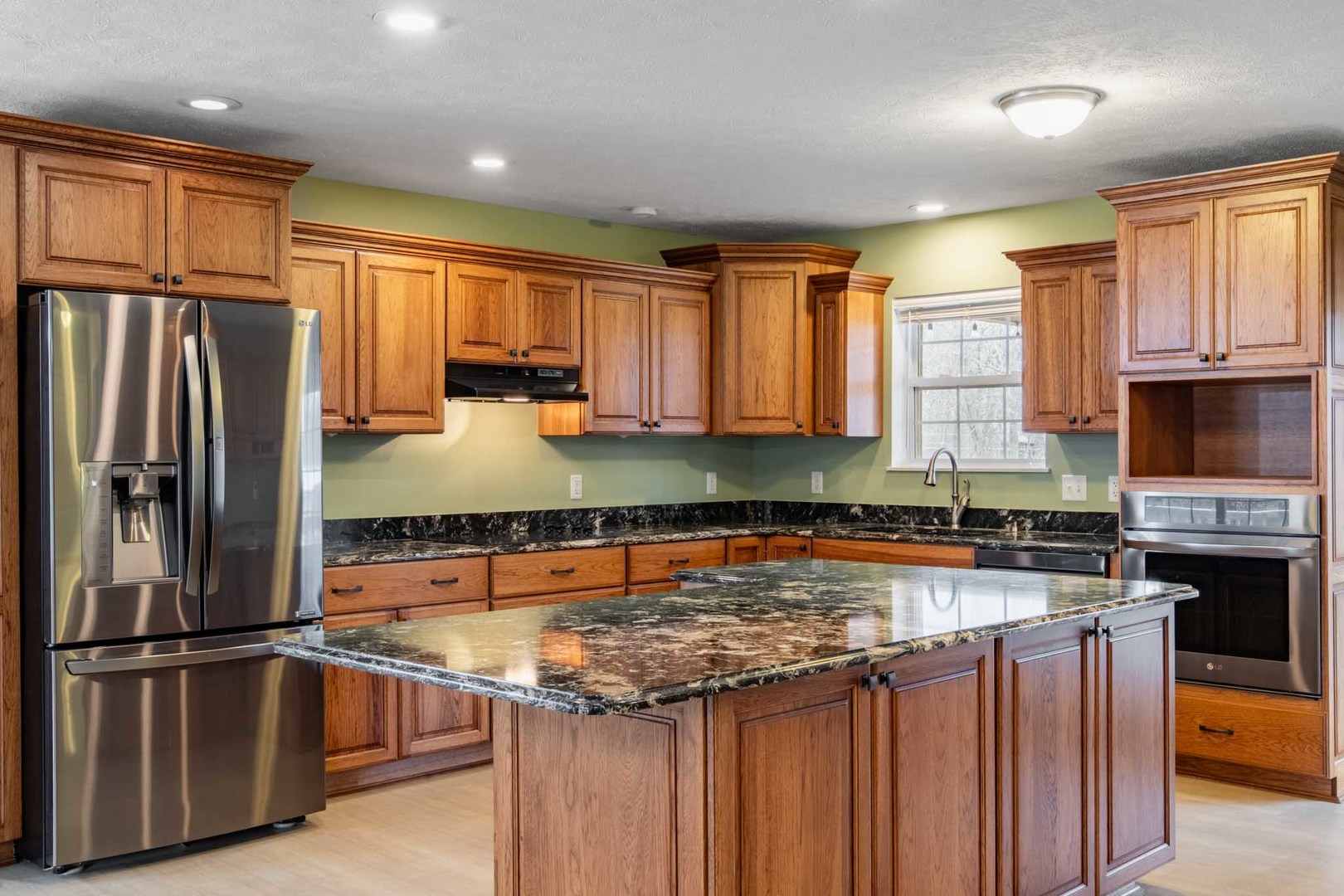 11052 Prestwick Drive Benton, IL 62812 - Photo 11 of 46 a kitchen with a refrigerator a sink and wooden cabinets
