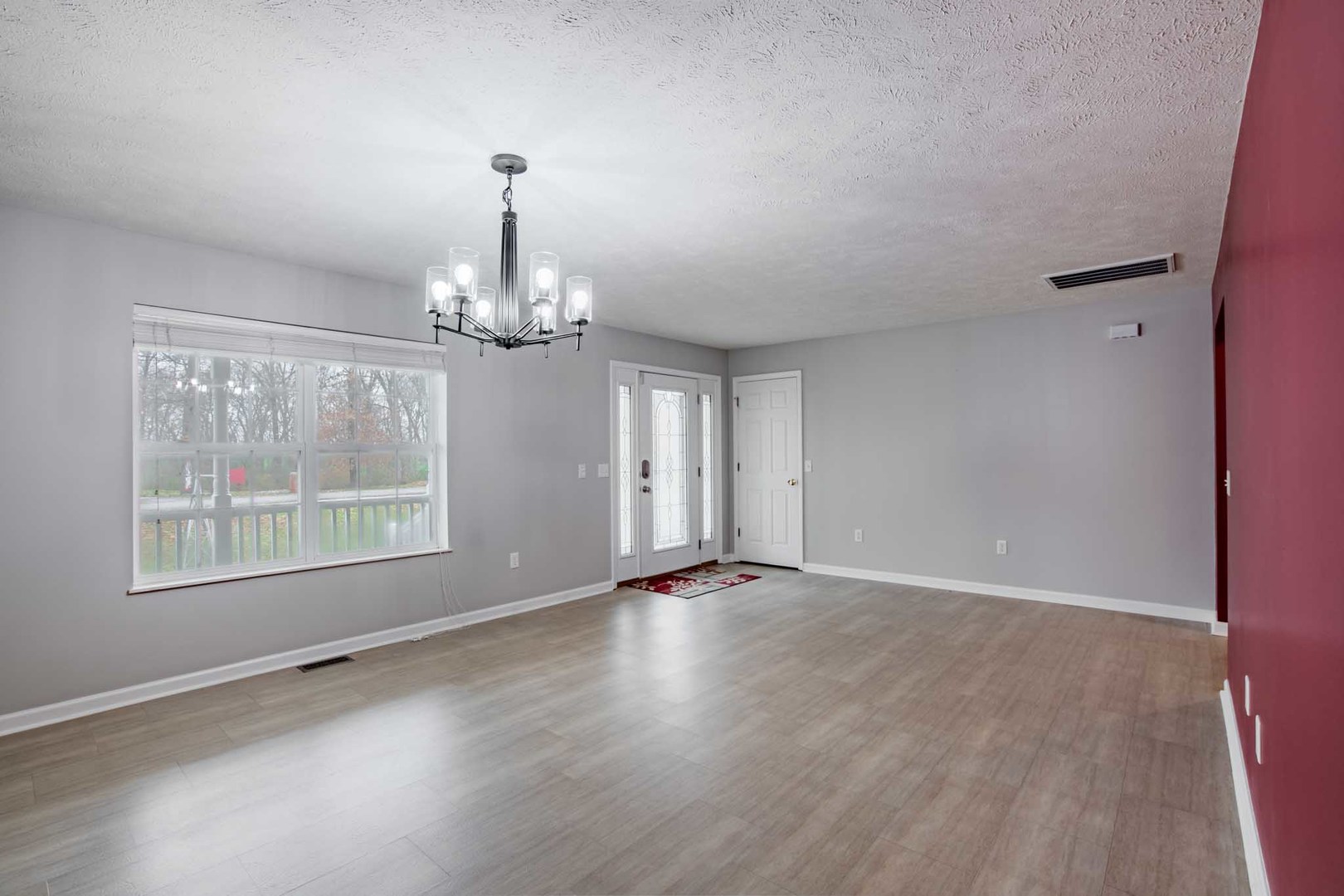 11052 Prestwick Drive Benton, IL 62812 - Photo 14 of 46 an empty room with wooden floor chandelier and windows