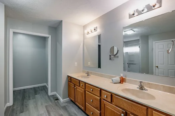 a bathroom with double vanity sink and a mirror