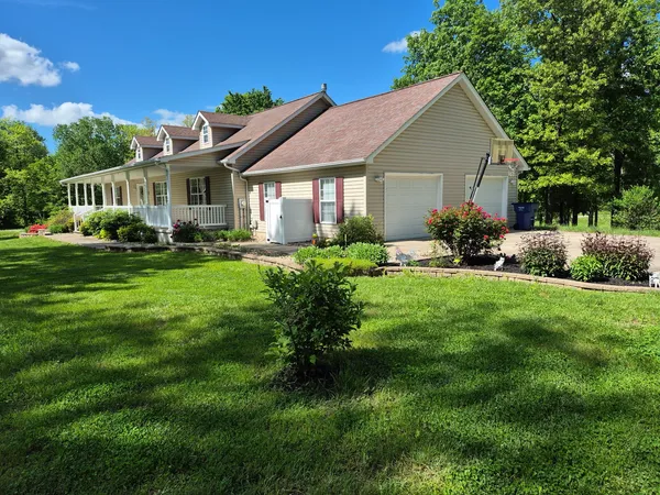 a front view of a house with a garden and porch