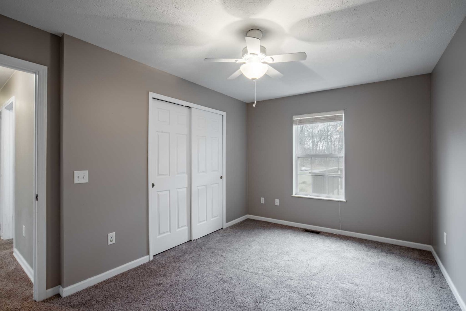11052 Prestwick Drive Benton, IL 62812 - Photo 31 of 46 an empty room with chandelier fan and windows