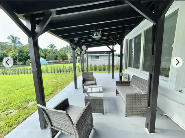 a view of porch with a table chairs and a floor to ceiling window