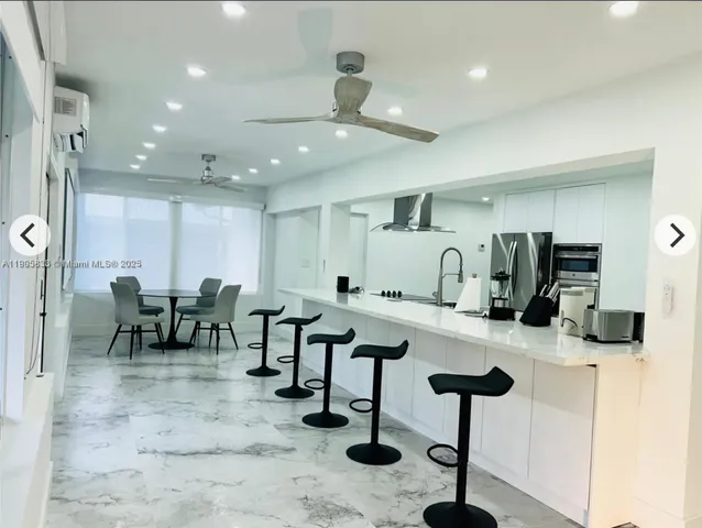 a room with lots of chairs and mirrors