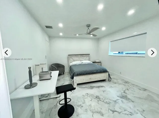 a bedroom with a bed and chandelier