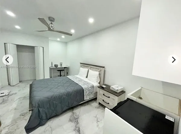 a bedroom with a bed and a walk in closet