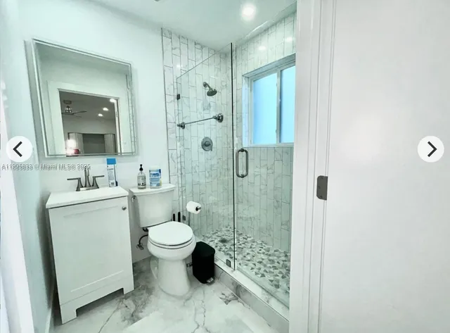 a bathroom with a toilet sink and a shower