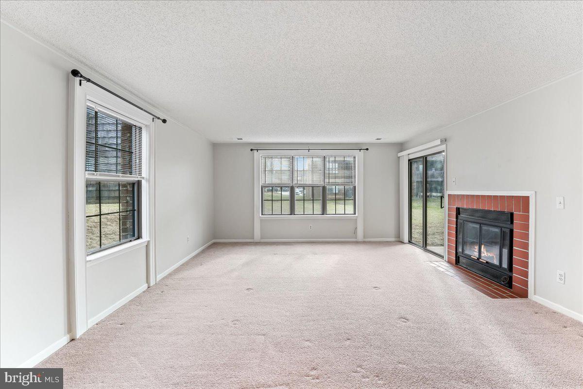 44 Witherspoon Court, Unit 137 Chesterbrook, PA 19087 - Photo 9 of 26 an empty room with windows and fireplace