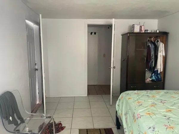 a bedroom with a bed and a dresser