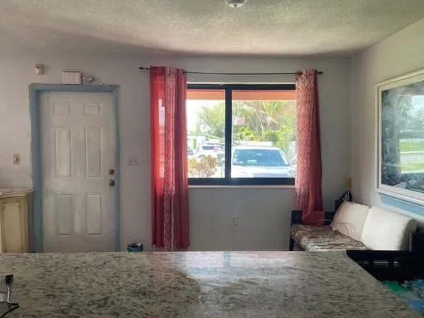 a view of a room with a large window and bed
