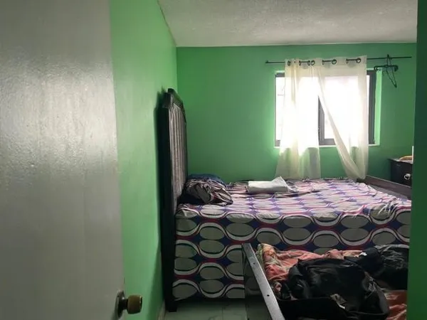 a bedroom with a bed and a window