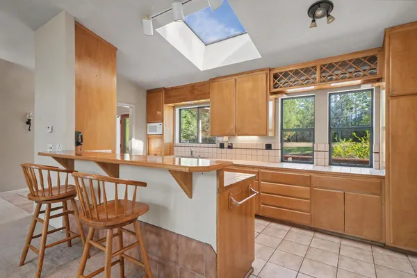 a large bathroom with a large window and a sink