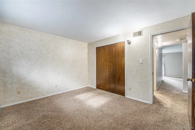 a view of an empty room and closet area
