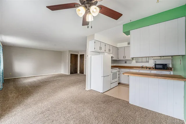 a view of a kitchen with cabinets and stainless steel appliances