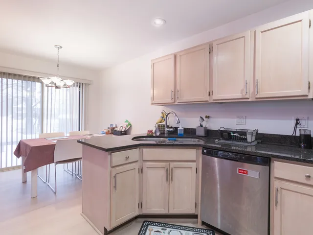 a kitchen with granite countertop a sink white cabinets and a granite counter tops