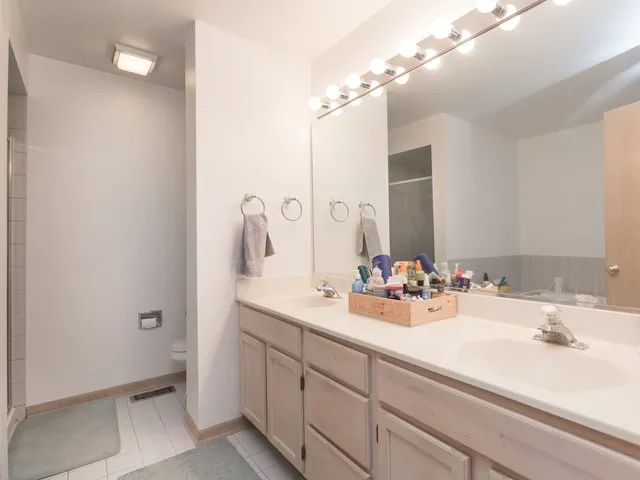 a bathroom with a sink double vanity and a mirror