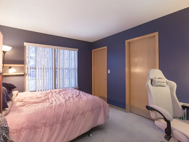 a bedroom with a bed and a chair